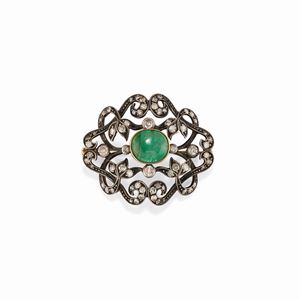  - A 18K yellow gold, silver, emerald and diamond brooch