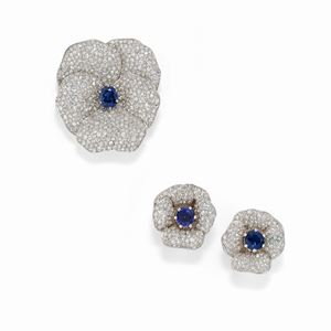 A 18K white gold, diamond and sapphire demi-parure, with brooch and earrings (defect)