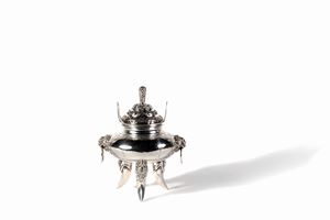 Silver incense burner with dragon-shaped feet, lion heads, perforated lid and inscriptions on the edges, China late 19th - early 20th century