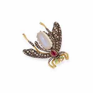  - A silver and colored gemstone brooch 