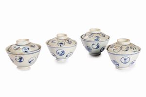Set of four blue and white porcelain teacups with lids, China, early 20th century