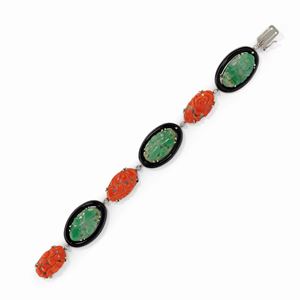 A 18k white gold, onyx, jadeite, diamond and coral bracelet, defects