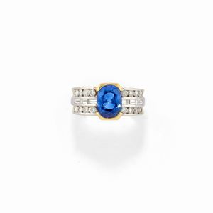 A 18K two color gold, sapphire and diamond ring