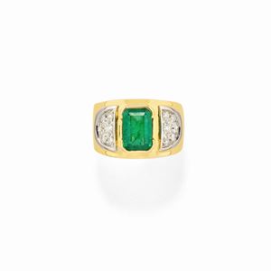 A 18K two color gold, emerald and diamond ring