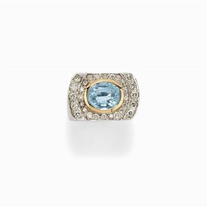 Anello in oro bicolore 18k, diamanti e topazio azzurro