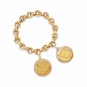 A 18k yellow gold charms bracelet with two coins