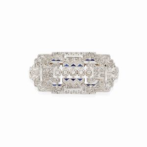 A platinum, 18K yellow gold, diamond and sapphire brooch