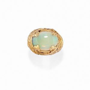  - A low title gold ring with opal