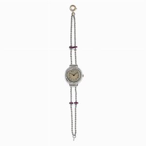 A platinum, ruby and diamond lady's wristwatch, Genève