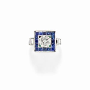 A 18K white gold, diamond, emerald and sapphire ring