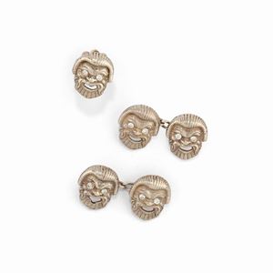 A silver and uncolored synthetic gemstone cufflinks and pin