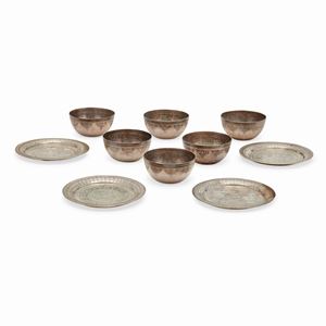 Four silver plates and six silver bowls