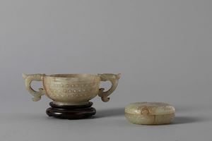 A small cup with handles and a carved celadon jade small box with cover. China, 19th century
