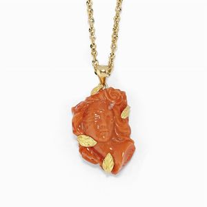 A gold and coral pendant