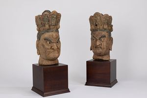 A pair of carved wood heads. China, 19th century