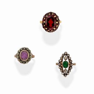 A silver, 18k yellow gold, emerald, amethyst, garnet and diamond three rings