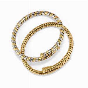 Due bracciali in oro 18k e acciao