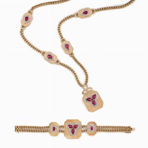 Parure in oro bicolore 18k, rubini e diamanti