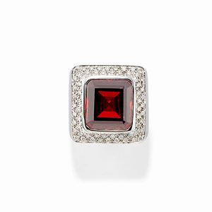  - A 18k white gold, diamond and garnet ring