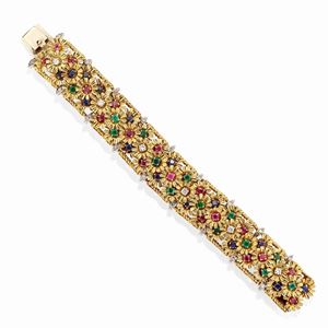 A 18k two-color gold, emerald, ruby, sapphire and diamond bracelet
