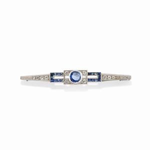  - A platinum, 18k white gold, sapphire and diamond brooch