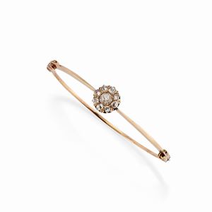 A 18k yellow gold and diamond bangle