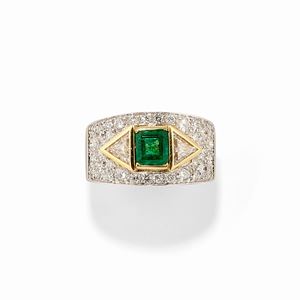 A 18k two-color gold, emerald and diamond ring