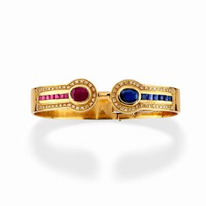 A 18k yellow gold, sapphire, ruby and diamond bangle