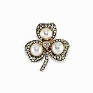 A silver, gold, cultured pearl and diamond brooch