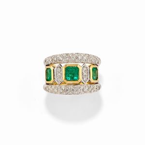 A 18k two-color gold, emerald and diamond ring