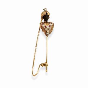 A silver, 18k yellow gold, ruby, diamond and wood brooch