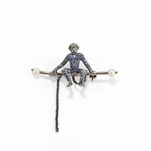 A 18k white burnished gold, cultured pearl, sapphire and emerald brooch