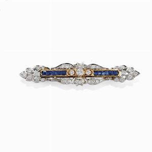 A 18K two color gold, diamond and sapphire brooch