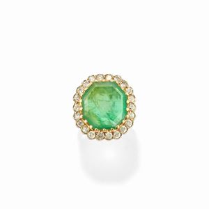 A 18k two-color gold, emerald and diamond ring