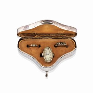 A silver box, Birmingham, 1919, Sanders & Mackenzie, inside three rings