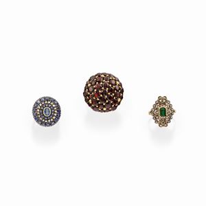 Three 18k yellow gold, silver, garnet, sapphire, emerald and diamond rings