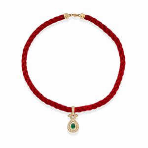 A 18k two-color gold, emerald, diamond and sapphire pendant