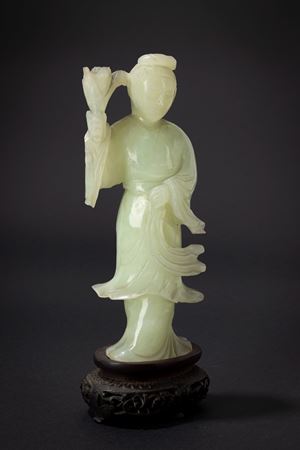 A green jade carving of a lady with flowers. China, 19th c.