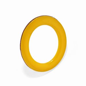 A burnished silver, yellow bakelite and ruby bangle