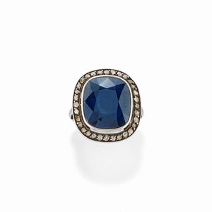 A silver, diamond and sapphire ring